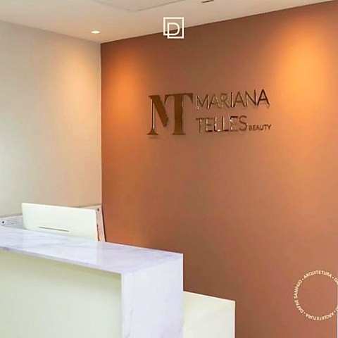 Recepção de clínica com parede terracota e logotipo